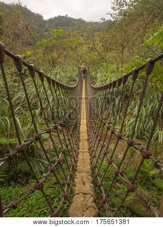 Shifen Taiwan - October 05 2016: Rope bridge over a river in the mountains near Shiften