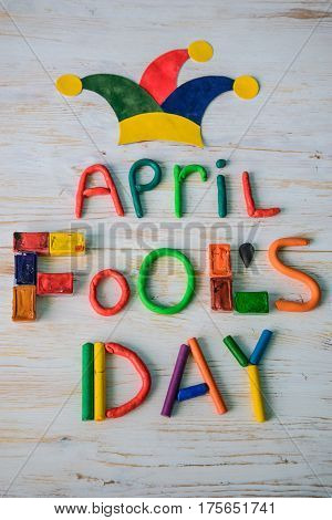 April Fools' Day text made with plasticine on white wooden background