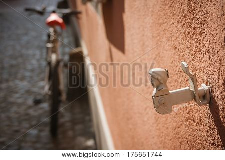 Old windows shutter holder close-up, bicycle, wall