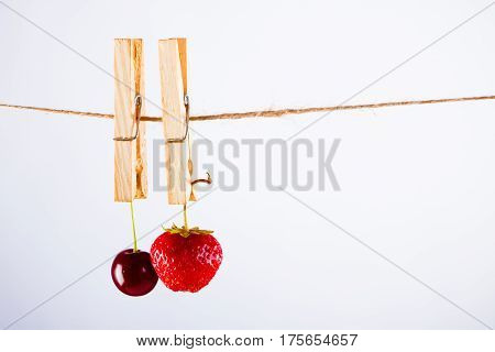 Red Cherry and rope on white with clamp fruit concept - desert, food