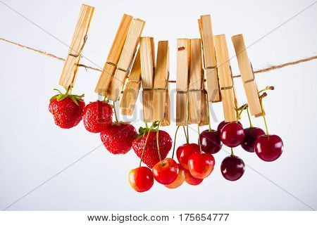 Red Cherry and rope on white with clamp fruit concept - desert, food