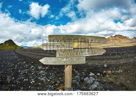 pointer against the backdrop of a desert mountain landscape. Treking in National Park Landmannalaugar, Iceland. Travel photography concept