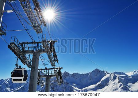 the cabin of the ski lift rises to the peak of the mountains. mountain landscape with ski-lift. photo on the theme of ski resort, winter sports, recreation, travel.