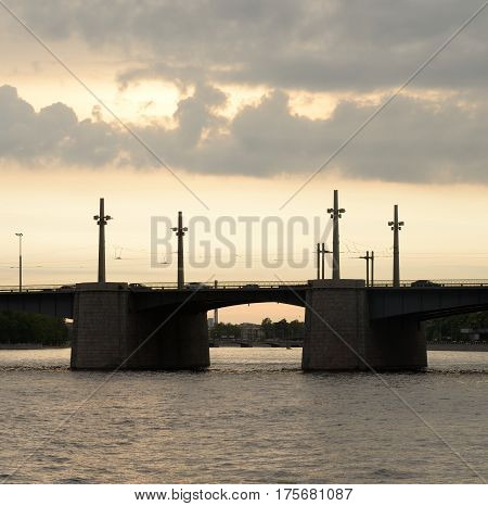 Silhouette of Kantemirovsky Bridge at sunset - connects the right bank of the Neva River and the Aptekarsky Island through Bolshaya Nevka in St. Petersburg Russia.