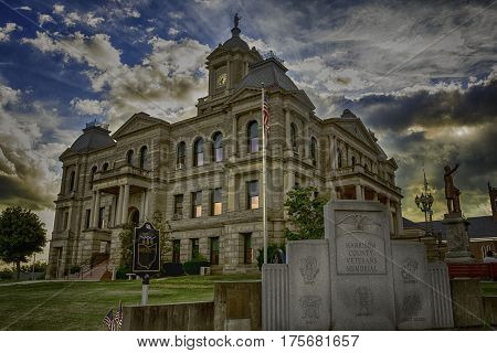 Cadiz Ohio USA- July 5 2016: The Harrison County Veterans Memorial with the Harrison County Courthouse standing in the background.