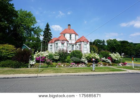 HARBOR SPRINGS, MICHIGAN / UNITED STATES - AUGUST 4, 2016: The Hexagon House, designed by Ephraim Shay as his home in 1892, has 6 hexagonal rooms on the ground floor, and was constructed of stamped steel.