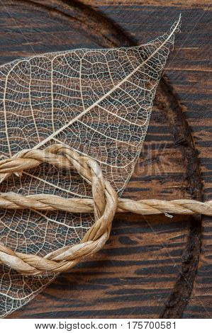 Macroshot of a brown wooden decoration with a leaf