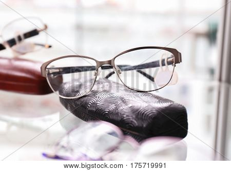 Shelf with glasses and spectacle-case in shop