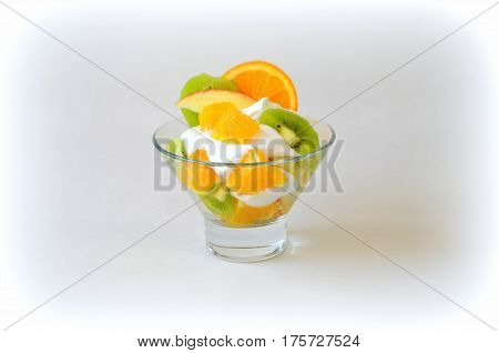 Dessert - fruit with cream, kiwi, apple and orange