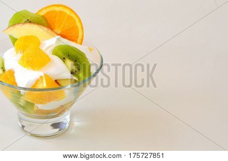 Dessert - fruit with cream, kiwi, apple and orange