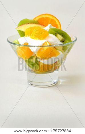 Dessert - fruit with cream, kiwi, apple and orange