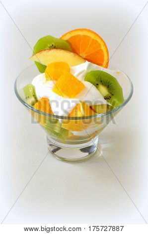 Dessert - fruit with cream, kiwi, apple and orange