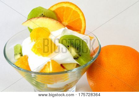 Dessert - fruit with cream, kiwi, apple and orange