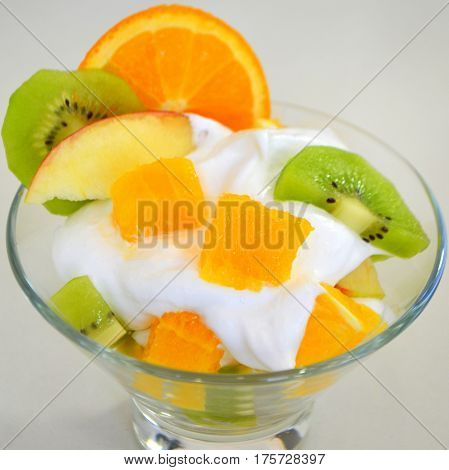 Dessert - fruit with cream, kiwi, apple and orange
