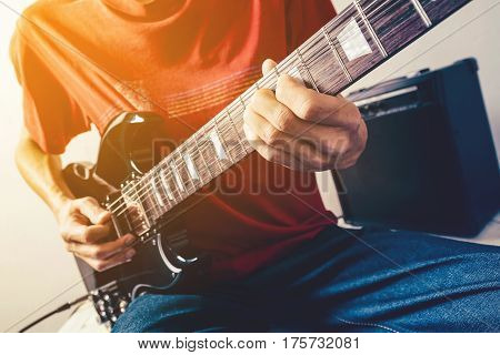 Close up shot of the man playing electric guitar