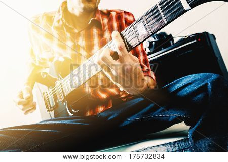 The man playing electric guitar, vintage tone