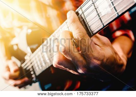 Close up shot of the man playing electric guitar