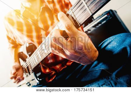 Close up shot of the man playing electric guitar