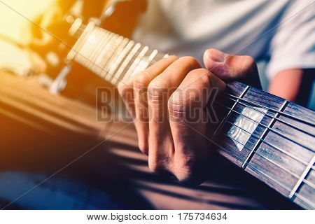 Close up shot of the man playing electric guitar