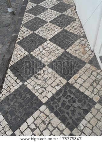 Typical Portuguese black and white stone mosaic 