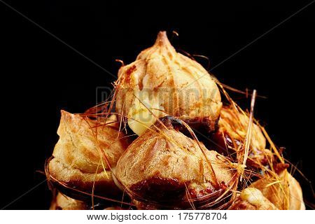 Cake Profiteroles With Caramel On Black Background.closeup.selective Focus