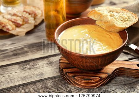 Delicious cream soup with bread on table