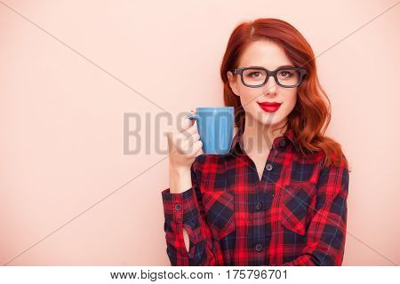 beautiful young woman with cup of coffee on the wonderful pinl background