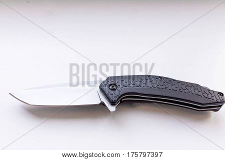 Pocket knife on a gray background. Type an angle.