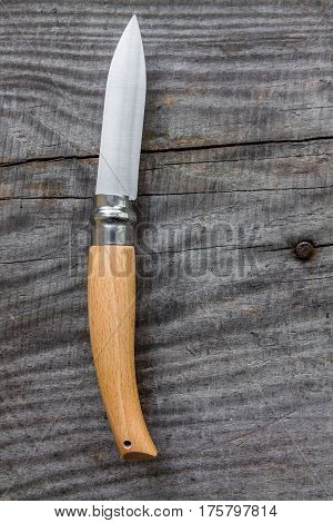 Knife for agriculture. Wood background. Knife with a unique mechanism.