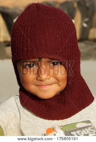 Goa, India - Feb 10, 2014: Portrait Of Little Indian Boy In Funny Hat On Sunny Beach Of North Goa