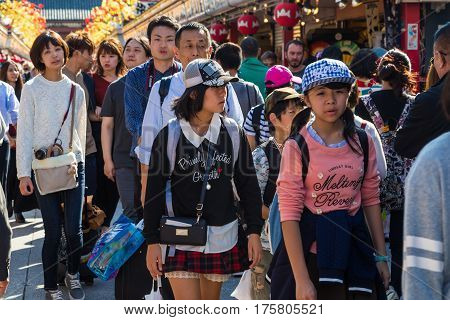 TOKYO JAPAN-October 20: Crowded people heading to the Buddhist Temple Sensoji on October 20 2016 in Tokyo Japan. The Sensoji temple in Asakusa area is the oldest temple in Tokyo.