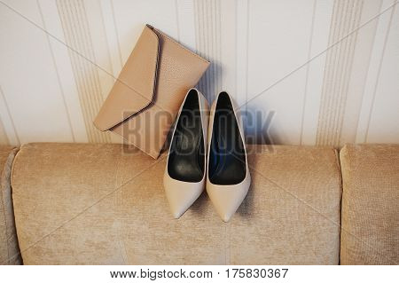 women beige suede shoes with clutch bag