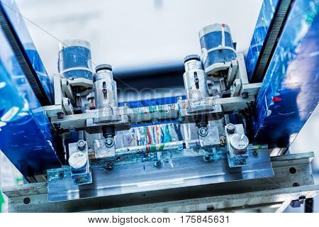 Print screening metal machine. Industrial printer. Serigraphy workshop.