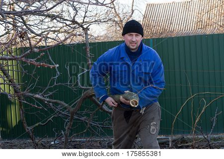 Man in working clothes working in the garden