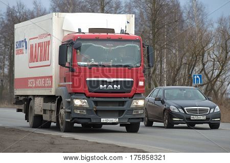 LENINGRAD REGION, RUSSIA - MARCH, 09 2017: Automobile Mercedes overtakes the MAN truck series TGS on the road
