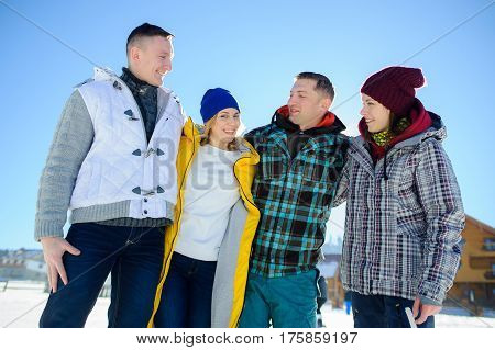 Cheerful group of friends posing for the camera. Two young men and two girl. All good mood. Friends are hugging and laughing merrily.
