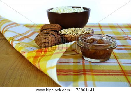 Cottage cheese in a brown bowl with oatmeal and jam
