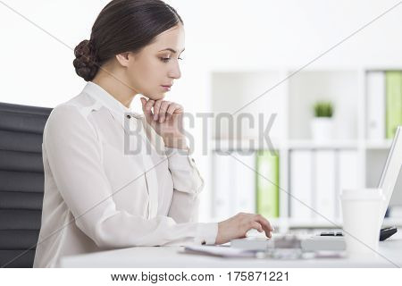 Side View Of Strict Woman Working In Office