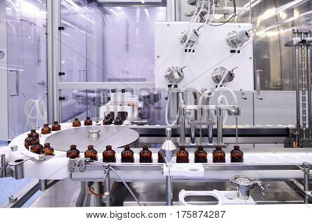 Sterile bottles and ampoules on the dispensing line. Sealed ampoules with medicine.