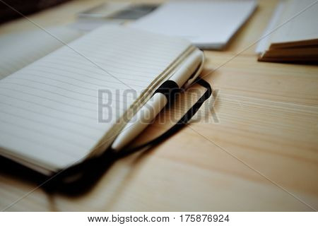 Blank stationery set on old wood background: business cards booklet notebook notepad and pen. Vintage style. Color