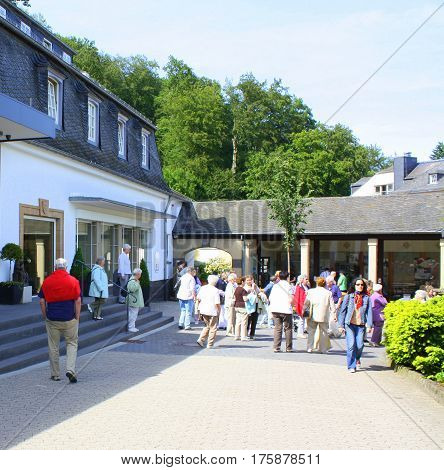 Maria Laach. May-24-2011. Tourists walking in the courtyard of Bendicte Abbey in Maria Laach. Germany