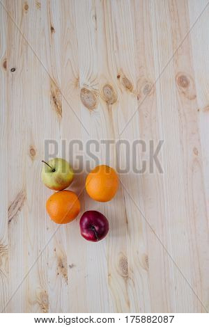 Fresh red and green apple, orange on wooden decks. Fruit, citrus table. Color