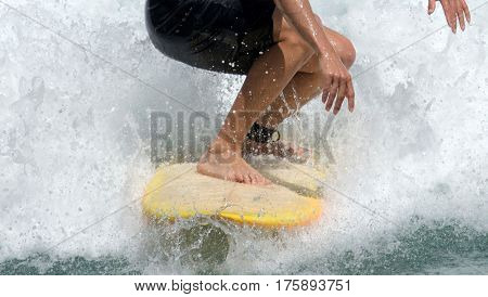Picture is cropped in tight on the surfers feet on the board