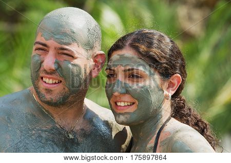 DALYAN, TURKEY - AUGUST 13, 2009: Unidentified couple pose for photo after taking mud bath in Dalyan, Turkey.