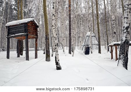 Irkutsk regionRussia-Feb18 2017: Warehouse and chum in Evenk nomad camp. Museum of Wooden Architecture Taltsy