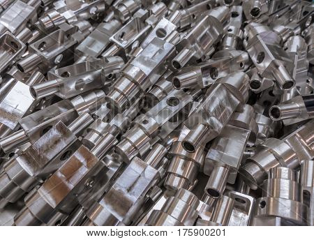 Shiny aluminium cnc machined parts background with selective focus close up technique.