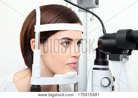woman doing eyesight measurement with optical slit lamp