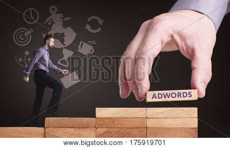Business, Technology, Internet And Network Concept. Young Businessman Shows The Word: Adwords