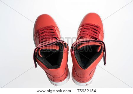 Fashion shoes with shoestring. Red sneaker and shoelace isolated on white background