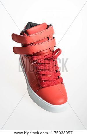 Fashion shoes with shoestring. Red sneaker and shoelace isolated on white background